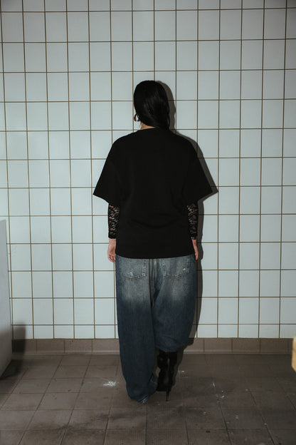 NO FLAG black T-shirt, full-length back view on a model.