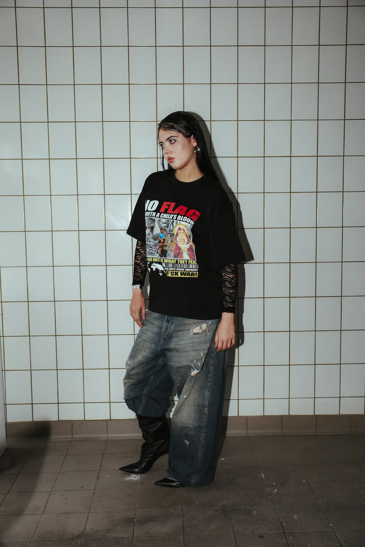 NO FLAG black graphic T-shirt, side view on a model showing sleeve length and fit.