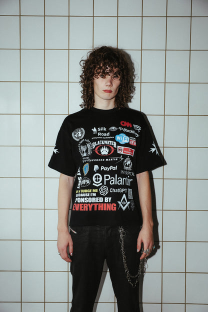 Sponsored by Everything black graphic T-shirt, front view on a model showing the collage print and sleeve crosses.