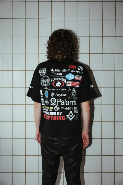 Sponsored by Everything black graphic T-shirt, back view on a model showing the large collage print.