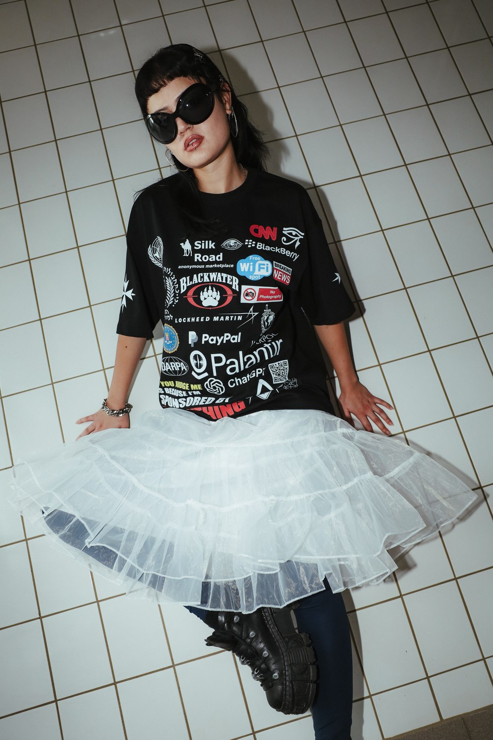 Sponsored by Everything tee styled with sunglasses and a white skirt